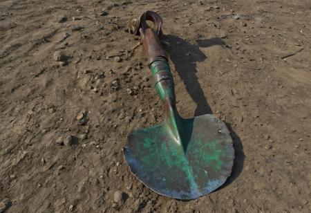 score_9, score_8_up, score_7_up, score_6_up, score_5_up, score_4_up,<lora:Fant5yP0ny:0.8>, Shovel; This long hafted, wide headed shovel is equally suited for digging as well as fighting.  The head is made of green steel while the haft is wrapped in dark leather.