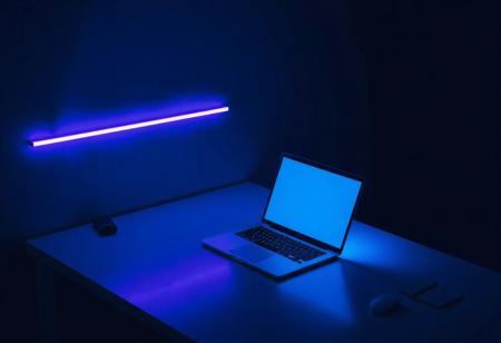 Minimalist cyberpunk workspace: a clean desk with a sleek laptop glowing softly with neon blue light, a single LED strip casting subtle purple hues, sparse notes neatly arranged, dark background, futuristic yet simple.