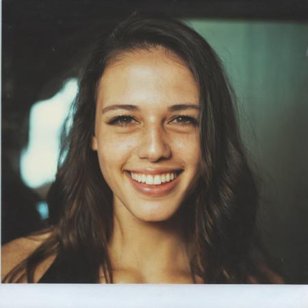 candid polaroid photo of T1T0N face, smiling, light leaks