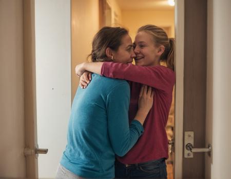 (a view into a cluttered appartment through a door-gap. two hugging_attractive_danish_college-women in the distance). wearing leggings,intimate moment,21 years old, highly detailed, film grain, bad lighting, ,lascivious smile,<lora:add-detail-xl:1.5> <lora:NaturalBodyXL-V1.1:0.15> <lora:xl_real_beta1:0.25>