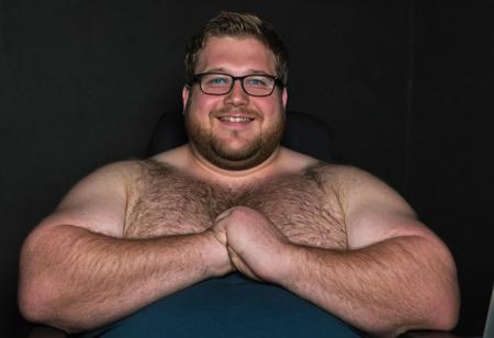 (((seen from below, pov below, sex pov, gay chubby porn))), ((cinematic hazey atmosphere, romantic movie, romance film, arthouse film)), ((dark, night nighttime, dark background, shadows)), Tanned chubby 30 year old bavarian man, wearing a black muscleshirt and blue jeans, light brown-blonde messy hair, stubble, doublechin, broad face, blue green eyes, big fat arms, big neck, broad neck, big belly, (nerd, programmer, coder), gentle smile, (sitting in dark office at night while programming on a high-tech computer),