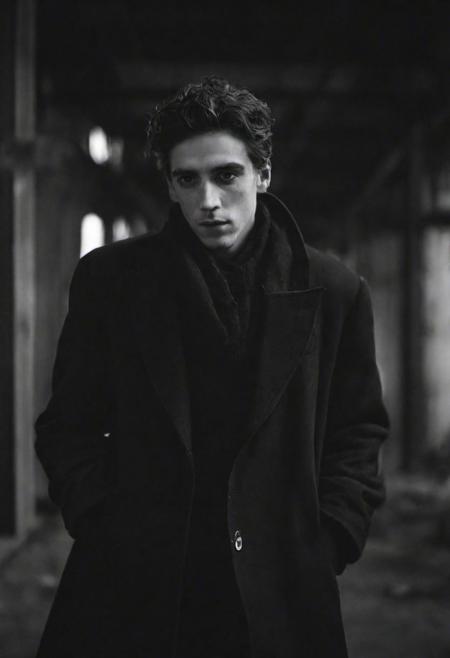 tyson_dayley <lora:tyson_dayley-08:0.75> , urban gritty location, posing in an industrial setting with steel beams,  Timothy tchalamet, natural lighting, dramatic directional lighting, bold confident mood, black and white Peter Lindbergh photography