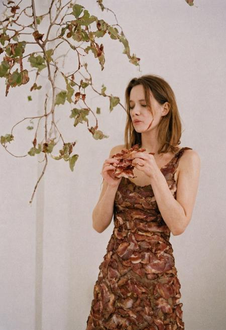 Model photography, the 1990s, bacon, a tree with bacon leaves, beautiful, in a white room, beautiful bacon blossom tree, a female eating bacon, wearing a brown dress, white lighting, film grain, DSLR