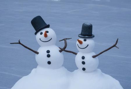 shows two snowmen standing close together on a snowy surface