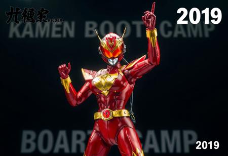 Center stage stands the Cyber Angel woman Dakini, vibrant in red and gold, poised for action with one arm uplifted. Her helmet, bearing a red visor and gold emblem, matches the striking color scheme. The backdrop, Bear's Boot Camp, provides a stark contrast. Top left, "Kamen Rider" is inscribed, while the bottom right corner reads "2019". The figurine, in high resolution, is the focal point, exuding energy and movement with its dynamic pose. The contrasting colors, text, and background offer context and intrigue. The image is a celebration of the character and anime, enhanced with vivid emotions, sharp details, and captivating lighting.