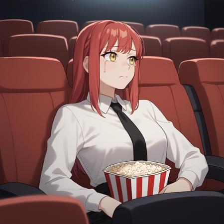 movi3theater sitting, red seats, dark room, popcorn