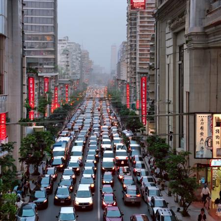 photo of a busy city street with cars and people