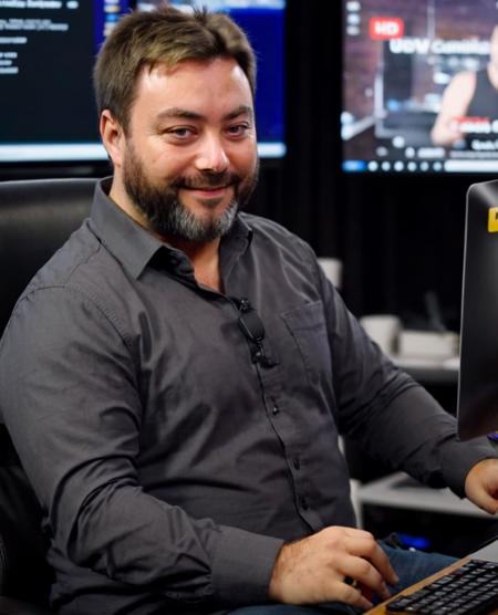 <lora:XL_sargon_v11:1>, carlbenjamin, smiling, wearing shirt, sitting in front of computer,  XL_ZIP_realism