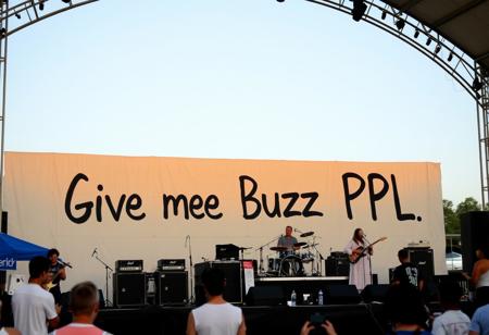Joe Russo's Almost Dead Live at Summer Concert Stage at Island Waterpark on 2024-07-13, big Sign on wall says "Give me Buzz PPL"