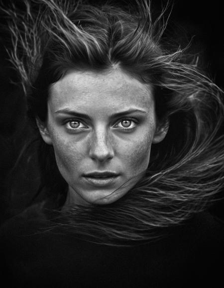a upper body black and white portrait of a pale woman with on her face, max rive, windblown dark hair, photo [far], whirlwind, photo 2010, face with artgram, lens dust, hdr human detailed, simple black background, backlit, taken with sony alpha 9, surf photography, thumbprint, (low contrast:1.4) flash-photography, (flim grain:1.6)