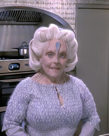 cardassian, female, mila, grey skin, silver white hair, reptile scales on sides of neck, perfecteyes eyes, wearing blue dress with fuzzy printed shawl, medium shot, cooking, (in a sci-fi kitchen:1.3), julianna mccarthy, (front view:1.2), indoor lighting, <lora:cardassian_lora_v2:0.8>,  <lora:locon_perfecteyes_v1_from_v1_64_32:0.2>