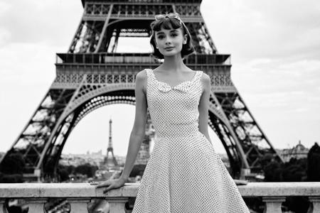B & W Photo of a young 20yo Audrey Hepburn in a polkadot summer dress in Paris, Eiffel Tower in the background, Canon 5d Mark 4, Kodak Ektar