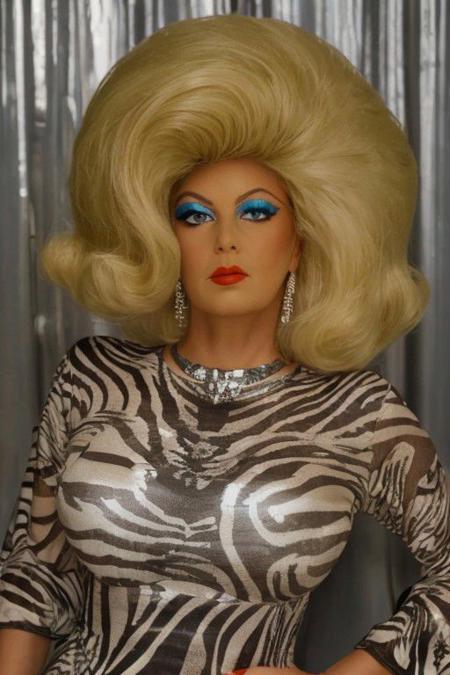 beautiful lighting, wide shot photo of a drag queen, (long eyelashes, thin eyebrows, eyeshadow, skin wrinkles, old face, Bouffant Hair, bouffant hair, heavy makeup, old, blonde hair, red lipstick, a woman with red lipstick,:1.5), wide shot photo of a drag queen dressed in(zebra print, long dress,:1.5), (huge 60's bouffant hairstyle, huge 60s hair, huge flip hairstyle, huge hair flip, huge very big 60s bouffant hairstyle:1.3), seductive, detailed eyes, shy smile, amidst emerald meadows, (perfect eyes, winged eyeliner,:1.5), holding a lasagna, centered, a photorealistic, golden daylight, backlight rim lighting, the orton effect, subtractive lighting, tilt-shift, cinematic, captured with a 85mm lens, bokeh, bokeh lighting, in the style of jessica drossin, soft lighting, detailed, RAW, analog, sharp focus, (photorealistic:1.3), (shadows:1.2), (intricate details:1.5), (sharpen details), background sun lens flare, sunshine, daylight, sky, photo by photographer Helmut Newton, highly detailed, sharp focus, cinematic lighting, dynamic poses, stunningly beautiful, captivating, enigmatic, exhibitionist, soft light, twilight, digital, high, ethereal lighting, dynamic composition, serene expression, primal energy, elemental beauty, high resolution, uhd, hdr, vogue photoshoot, Laocon, iris flare light