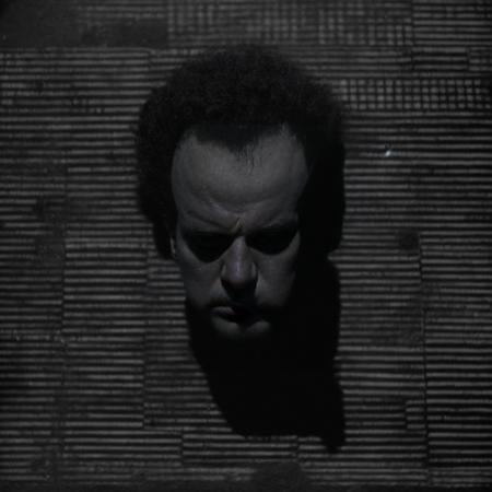 <lora:Eraserhead_Style:1> 3h3dstyl, (Black and white:1.5) surreal scene, inspired by Eraserhead, Henry Spencer's decapitated head lying on its side on a (vividly contrasted black and white checkered floor:1.5), highly visible tiles, eerie industrial room, soft but noticeable overhead lighting, subtle shadows, film grain, analog horror atmosphere, high contrast grayscale, surreal composition, unsettling mood, Lynchian aesthetics,
