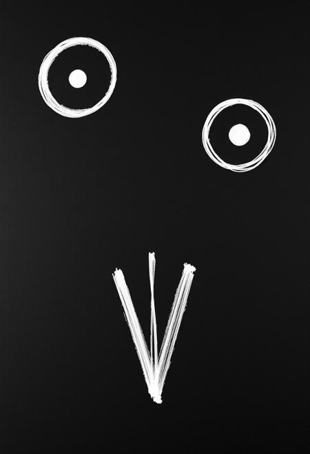 Imagine a black canvas, on this canvas are painted three symbols with white, the first symbol in the upper left region is a full circle with a tiny disk in its center, the second symbol is in the upper right region and is also a circle with a tiny disk inside, the last symbol is at the bottom center of the canvas, it looks like a capital "V" letter with a vertical line in its middle