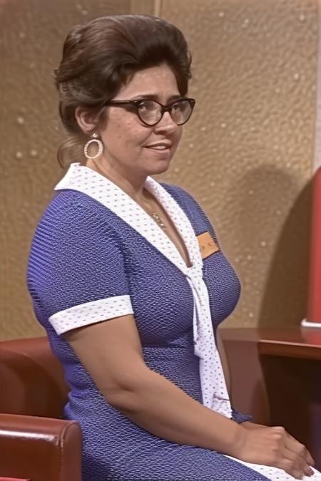 connie_tpir, woman, middle age, brown hair, hair in bun, hoop_earrings, 1960s, black frame glasses, blue polkadot dress, white polkadot neckerchief, nametag on chest, jewelry, necklace, smile, 