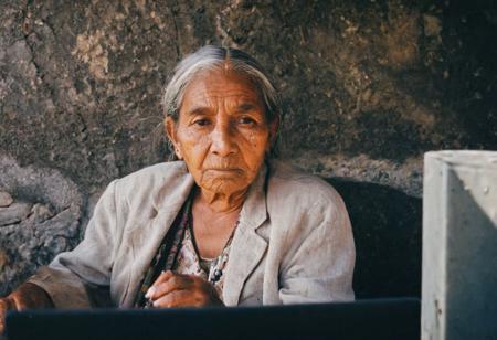 leica m3, 35mm Voigtlander lens, Portra 160/400, photo of a old Mexican indigenous woman, with a Quantum computer. high resolution, high contrast, natural  sunlight