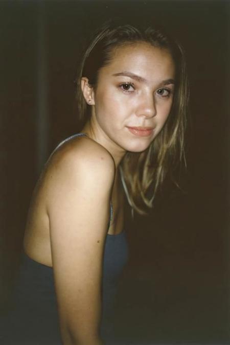 analog portrait photograph of a feminine french woman, dark room, Porta 160 color, shot on fujifilm, canon eos R