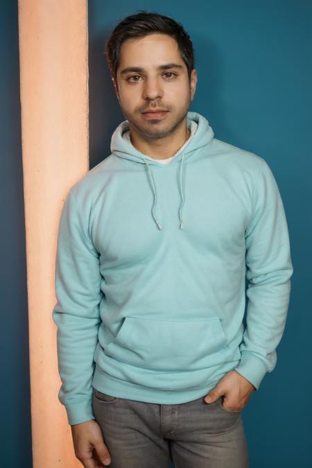 SatyaBhabha, stubble, 80's heartthrob, (1man), muscular, hunky male, (wearing a Retro-style sweatshirt), handsome, professional lighting, artistic shot, blue background <lora:SatyaBhabhaLora:1>