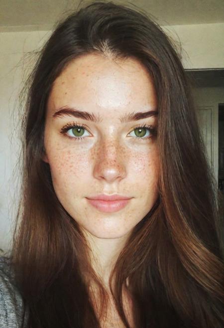 instagram selfie, upper body, a 23 year old gorgeous woman, slight smirk, detailed skin face and eyes, natural lighting, at home, long hair, low contrast, natural face, freckles, brunette hair, green eyes