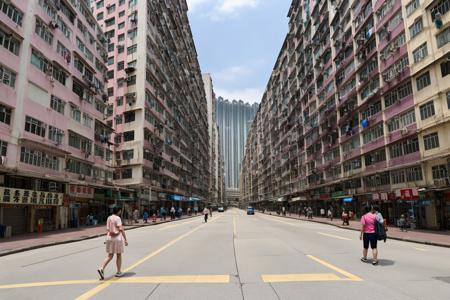 Hong Kong Old District, tall buildings, person walking on the sidewalk, (RAW photo, best quality), (realistic, photo-realistic:1.2), outdoor <lora:Hong Kong Old District:0.6>