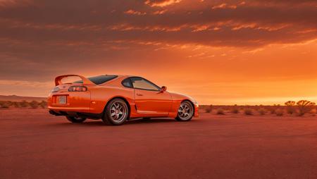 side photo of orange mk4Supra on desert road during sunset with dramatic orange clouds, high quality photo, lens flare, bokeh, 8k resolution, gobo lights, warm ambient light, volumetric light, neon lights, depth of field, analog, foggy atmosphere,  lens flares, light bloom, portra 800 film, <lora:Mk4Supra-000007:.6>, <lora:analogdiffusion_Lora300:.2>