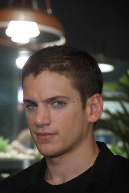 portrait, w3nm1l, handsome man, stunning eyes, upper body, short hair, buzz cut, in t-shirt, at the exotic aquarium, facial focus, amateur, candid