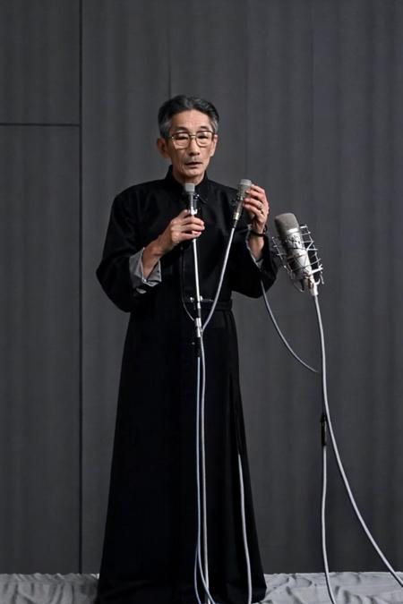 best quality, masterpiece,Grey background,unlined long gown,full body,Vertical microphone,looking at viewer, glasses,old men,<lora:masanli:0.8>