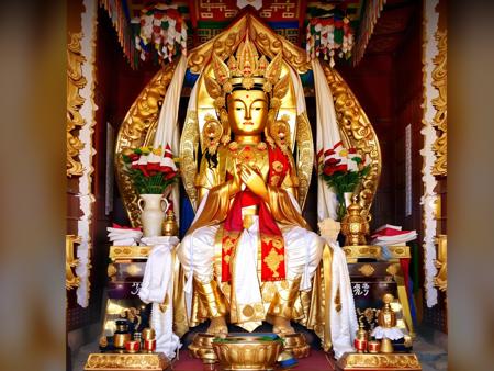 Mila, Maitreya Bodhisattva,Maitreya, a statue of a person with a gold head and a white robe on it's body and a red and gold robe on his head, candle, no_humans