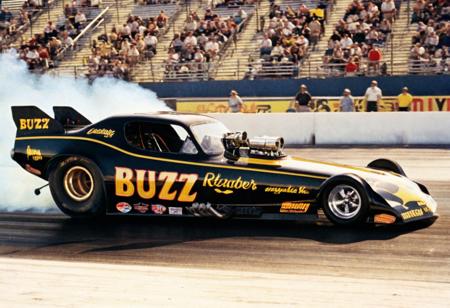 ClassicMuscleCar, black yellow dragster, side view, sunny, race track, people, smoke trail, 4K, highly detailed, (stylish grainy analog 35mm film photo, "BUZZ")