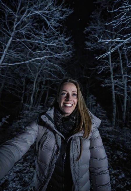 girl at night in the wood, selfie shot, dressed for trekking, winter, laughing, at night, very dark, infrared photography, without flash, grainy, ((motion blur)), blurry,  walking