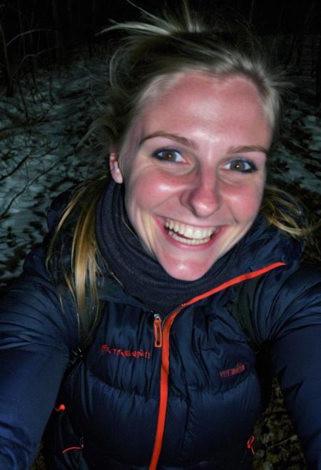 girl at night in the wood, selfie, dressed for trekking, winter, laughing, at night, creepy, very dark, without flash, grainy, ((motion blur)), blurry,  walking