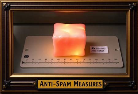 A high quality photograph with an art deco frame and title plaque at the bottom of "Anti-Spam Measures" picturing a block of pink flesh with a glowing yellow aura on a measuring board. There's a small warning label next to the pink block stating "Warning: Anti-matter".