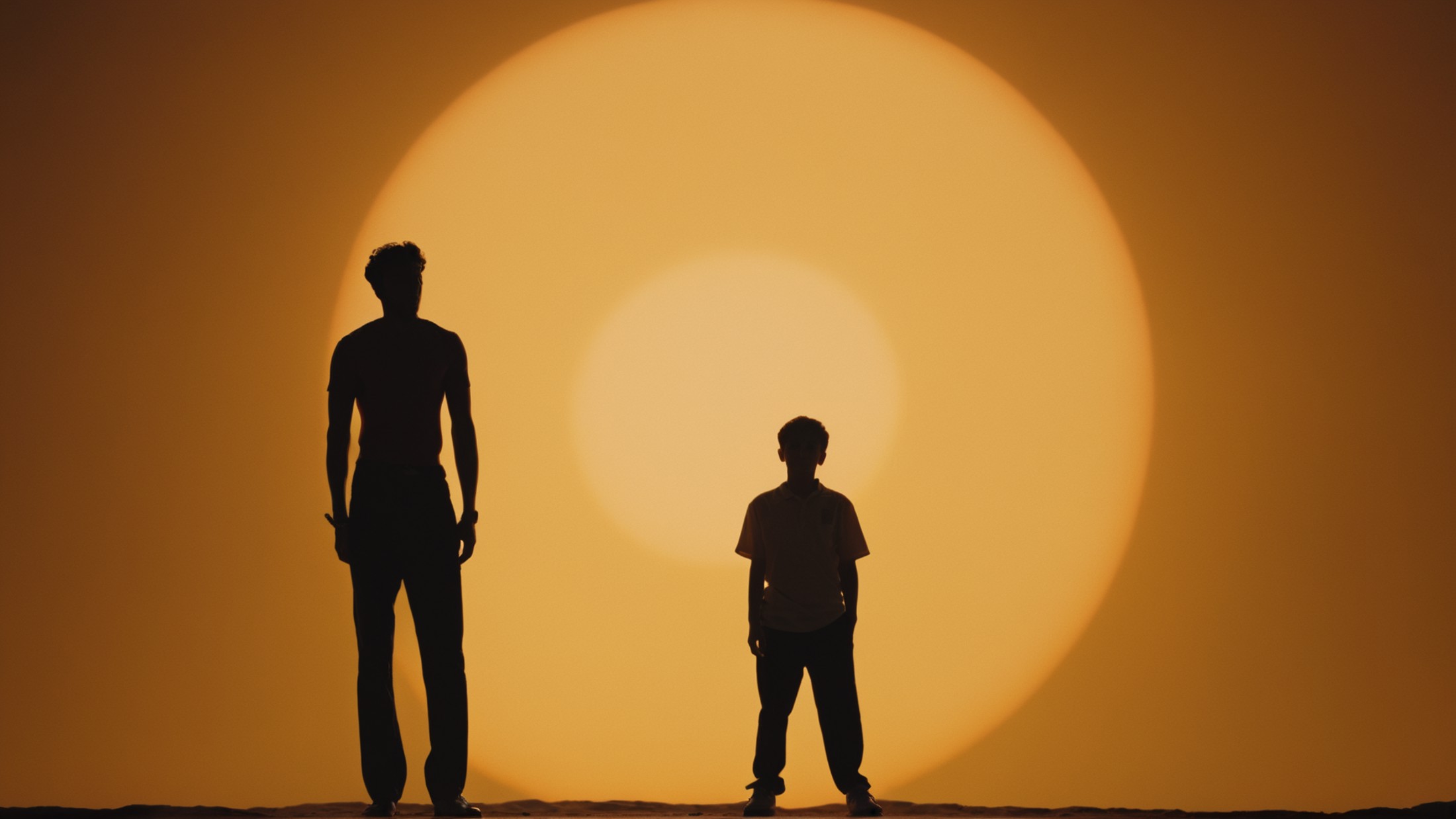 cinematic film still of  <lora:silhouette style:1>
A silhouette photo of a man standing in front of a large sun,1boy,stand...