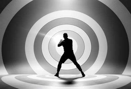 A chrome and silver beam hitting a human 100 metres away. The beam is about 1 metre thick and surrounded by multiple concentric grey and white circles of varying diameter. The target is silhouetted and is in an action hero pose