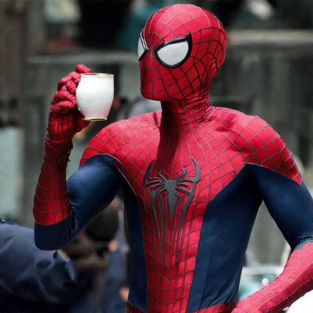 tasm2spdrmn holding tea cup in his hand <lora:tasm2spdrmn_v4:0.75>