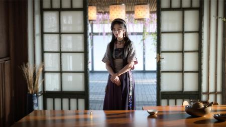 a young girl standing in front of a table with a vase and a vase on it's side, (1girl:0.991), (3d:0.860), (architecture:0.800), (ball:0.874), (black hair:0.753), (blurry:1.000), (blurry background:0.998), (blurry foreground:0.974), (depth of field:1.000), (east asian architecture:0.888), (floral print:0.512), (indoors:0.741), (jewelry:0.924), (lips:0.645), (long hair:0.785), (looking at viewer:0.778), (motion blur:0.575), (necklace:0.937), (photorealistic:0.727), (shouji:0.995), (sliding doors:0.990), (solo:0.839), (upper body:0.523), (window:0.620)