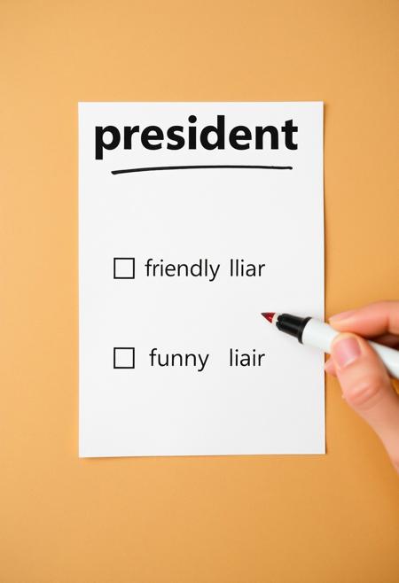 White paper with title "select your president" that presents two checkbox options. the first reads "friendly liar" and the second reads "funny liar", hand holding a marker ready to check a box