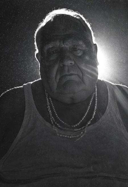 Retro 90s sensual romantic grainy dark lowlight photography, dark shadows, nighttime photograph, portrait,
dark cloister office bedroom,
solo, alone,
closeup, pov below,
Professional photography with dramatic dim light and dark shadows. The background is dark. The image has grain and noise.
A old obese musclechub grandpa with a thick neck and doublechin. He has tanned shiny skin. He is an old german european granddad.
He is wearing a long loose Tanktop. He is wearing a pearl necklace and golden jewellery.
dark grainy lowlight, very dark, noise,