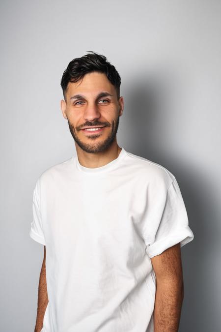 <lora:Rythmind_Loïc Barcourt_v4Final:1>
Loïc Barcourt Person, A photo of Loïc Barcourt wearing a white short-sleeved shirt. He has a beard and is looking directly at the viewer. The background is plain white and the floor is also white. The lighting is soft and evenly distributed casting minimal shadows., best quality, man, solo, male focus, photo, shirt, facial hair, white shirt, looking at viewer, simple background, beard, white background, black hair, t-shirt, short sleeves, smile, print shirt, front view, Happy expression