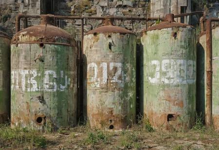 Rusty abandoned chemical tanks, large stenciled numbers on tanks, tanks are painted a weathered green color with a white stripe, outdoors, abandoned Soviet chemical facility, plumbing, pipes, Stunning background,
many details, extreme detailed, full of details,
Wide range of colors., Dramatic,Dynamic,Cinematic,Sharp details
Insane quality. Insane resolution. Insane details. Masterpiece. 32k resolution.