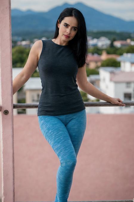 1girl, a woman in a pink top and blue leggings posing for a picture on a balcony with a mountain in the background, (depth of field), detailed face, (photorealistic, absurdres, best quality, masterpiece:1.4), (high detailed skin:1.3)
 <lora:krysten_ritter_lora_v01:1> ritter81, black hair, brown eyes