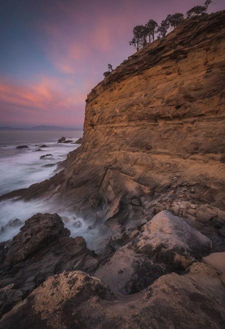 Capture the essence of a breathtaking landscape in the style of Michael Shainblum, using a Canon EOS R5 camera with a Canon RF 15-35mm f/2.8L IS USM lens. Position yourself at a high vantage point to take advantage of the early morning or late afternoon light,