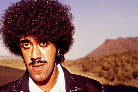 color photograph, ThinLizzy, TLPhil is 1boy  with a big afro, dressed as cowboy, west texas desert at sunset,  detailed glossy eyes looking at viewer, visible skin pores,  highres, dof<lora:TLPhil:1>