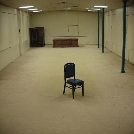a chair in the middle of a large room