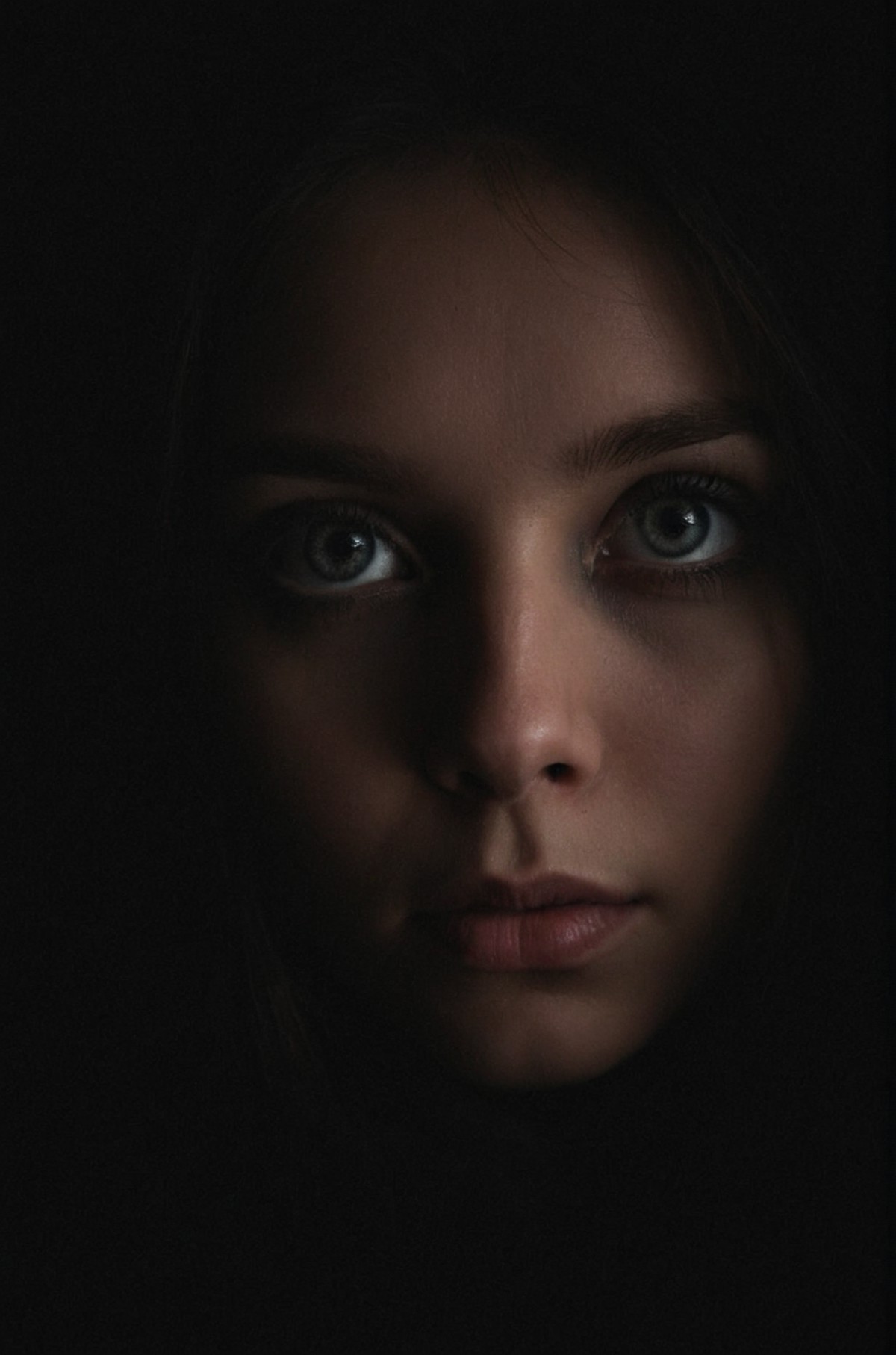 cozy lighting, dark background, portrait, unusual composition, use of negative space, spectral, eye close-up