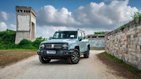 a blue gwm txxx parked on a dirt road near a large concrete structure or a stone wall, with a cloudy sky in the background. beautiful, hd, 8k, (photographic:1.5), magnificent, grandiose, mac os wallpaper <lora:GWMTank300_V2.0:1>