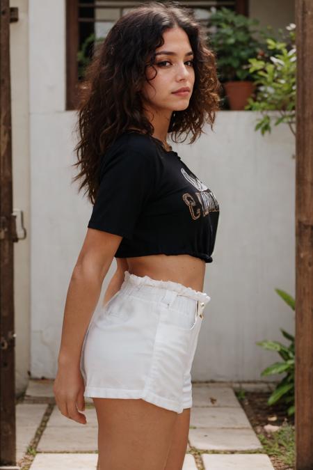 cowboy shot a beautiful Colombian woman with curly hair, ideal face, looking at viewer, ideal body, side view, t-shirt, black paperbag shorts, pale skin, detailed skin, natural lighting, film grain, Canon 5D, sharp focus on subject, Fujifilm XT-3, <lora:picxer_real:1.5>, <lora:btpabsho:0.7>