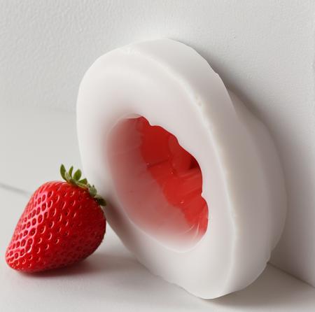 fleshlight detailed product in front of a white wall, orifice is shaped like a strawberry