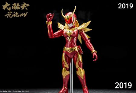 Center stage stands the Cyber Angel woman Dakini, vibrant in red and gold, poised for action with one arm uplifted. Her helmet, bearing a red visor and gold emblem, matches the striking color scheme. The backdrop, Bear's Boot Camp, provides a stark contrast. Top left, "Kamen Rider" is inscribed, while the bottom right corner reads "2019". The figurine, in high resolution, is the focal point, exuding energy and movement with its dynamic pose. The contrasting colors, text, and background offer context and intrigue. The image is a celebration of the character and anime, enhanced with vivid emotions, sharp details, and captivating lighting.